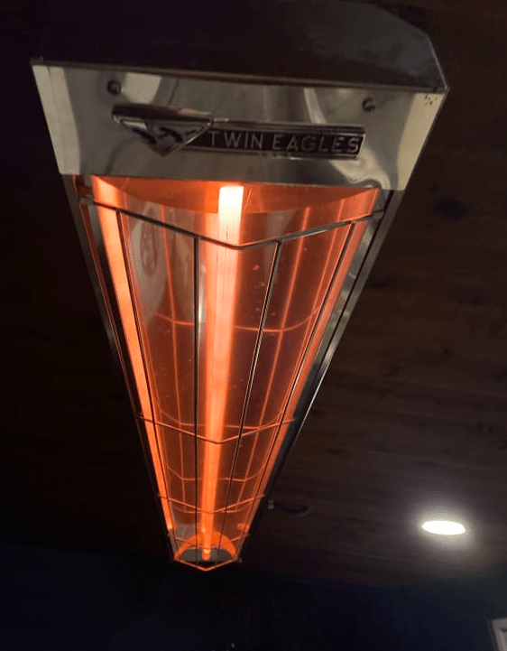 Twin Eagles electric radiant heater installed overhead with heating element glowing